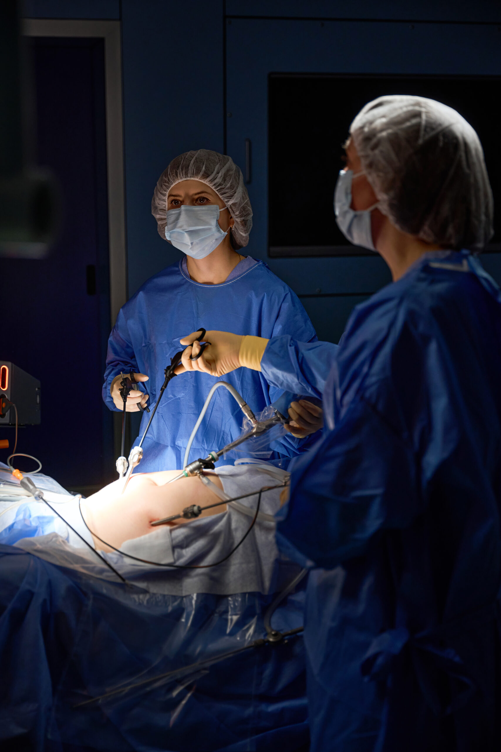 Surgical team performing a laparoscopic procedure in an operating theatre